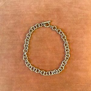 Sterling silver loop choker with toggle clasp.